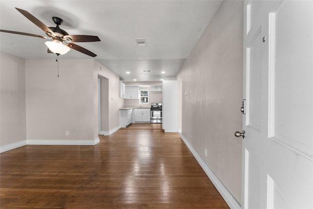 unfurnished living room featuring hardwood / wood-style flooring and ceiling fan