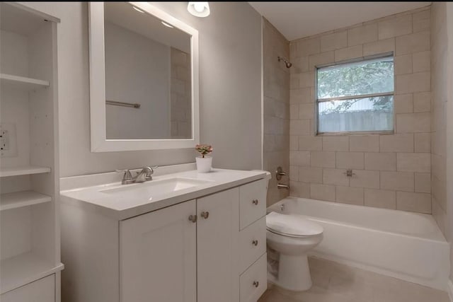 full bathroom featuring vanity, tiled shower / bath combo, and toilet