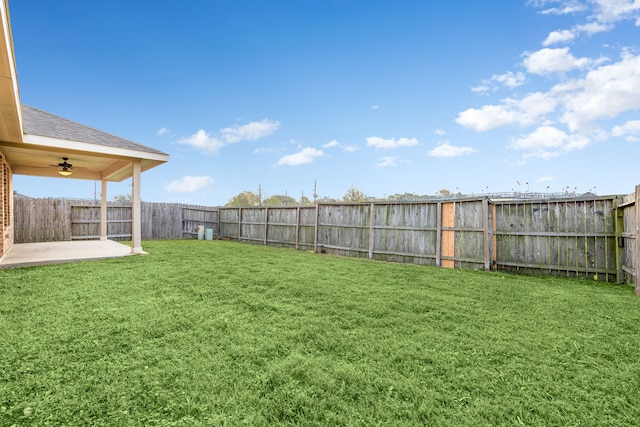 view of yard featuring ceiling fan and a patio area