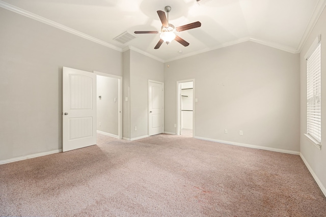 unfurnished bedroom featuring lofted ceiling, crown molding, ceiling fan, carpet floors, and a closet