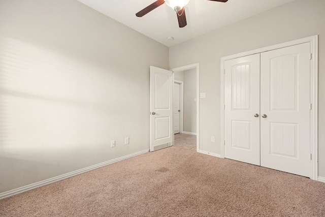 unfurnished bedroom with ceiling fan, a closet, and carpet floors