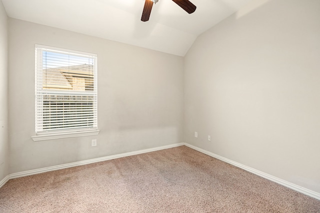 carpeted spare room with vaulted ceiling and ceiling fan