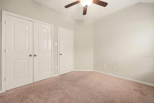 unfurnished bedroom featuring carpet, ceiling fan, lofted ceiling, and a closet