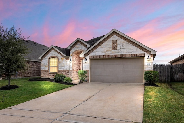 view of front of home with a yard and a garage