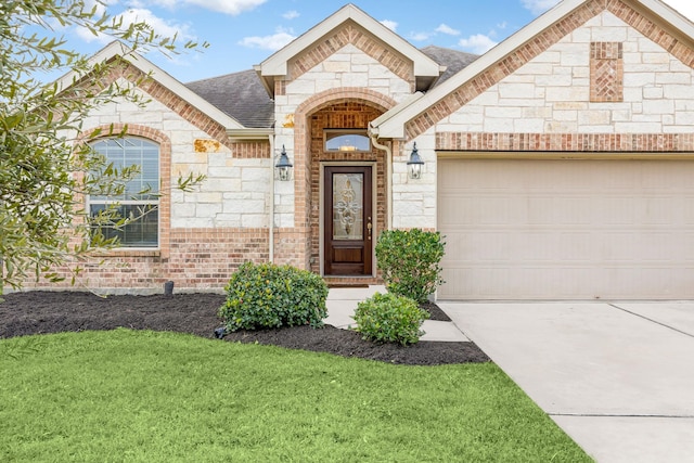 view of front of property with a front yard and a garage