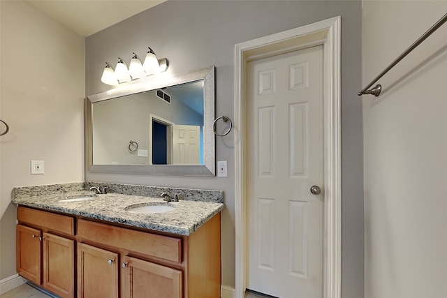 bathroom featuring tile patterned flooring and vanity