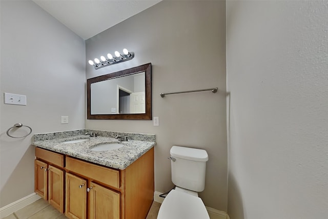 bathroom with tile patterned floors, vanity, and toilet