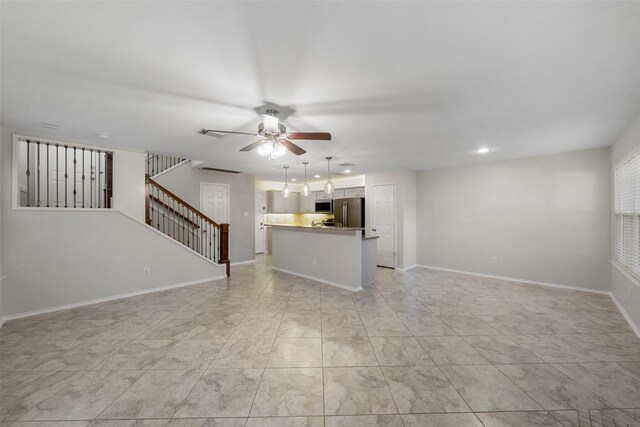 unfurnished living room with ceiling fan