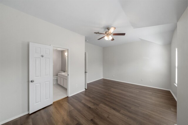 spare room featuring vaulted ceiling, ceiling fan, and dark hardwood / wood-style floors