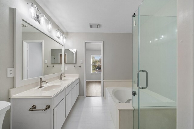 full bathroom with toilet, tile patterned flooring, vanity, and shower with separate bathtub