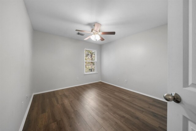 unfurnished room with dark hardwood / wood-style floors and ceiling fan