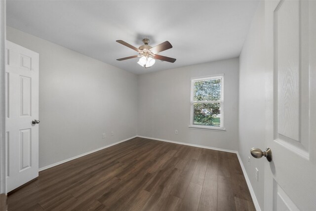 spare room with dark hardwood / wood-style floors and ceiling fan