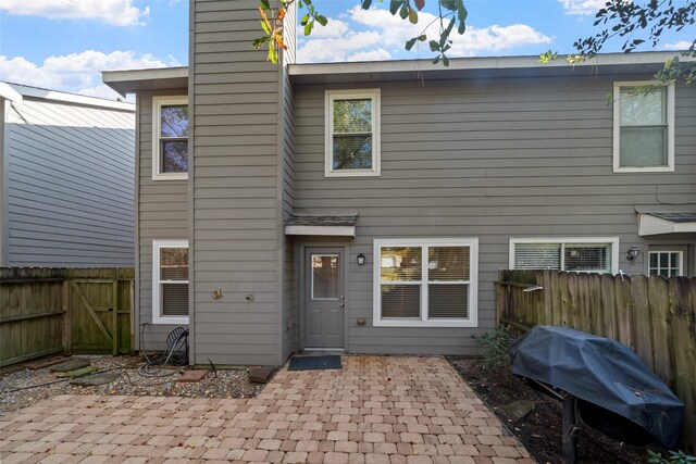 rear view of property featuring a patio area