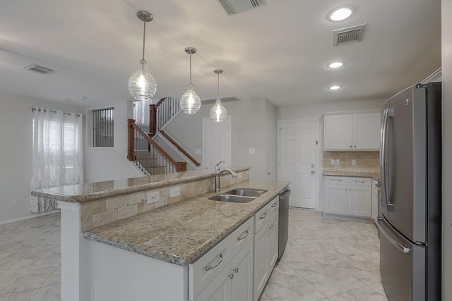 kitchen with visible vents, appliances with stainless steel finishes, and a sink