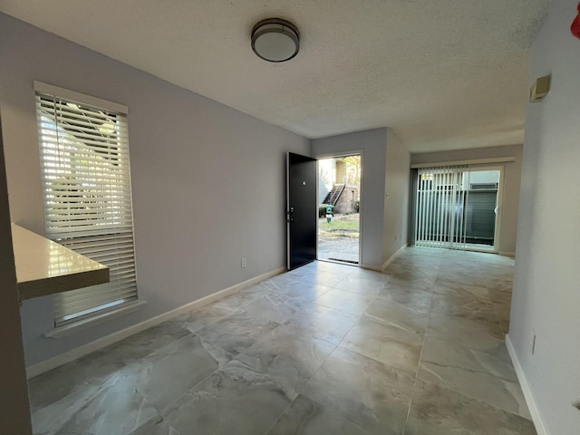 interior space featuring a textured ceiling and a wealth of natural light