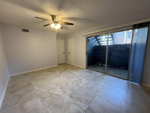 empty room featuring ceiling fan and a textured ceiling