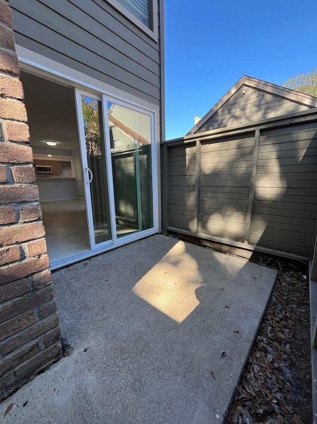 view of patio / terrace featuring an outbuilding