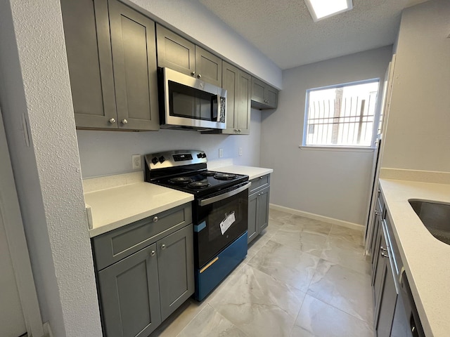 kitchen with gray cabinetry, black electric range oven, and a textured ceiling