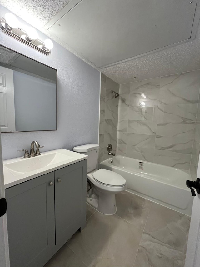 full bathroom with toilet, vanity, a textured ceiling, and tiled shower / bath