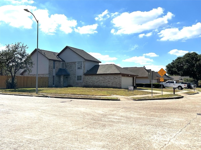 view of front of property with a front yard and a garage