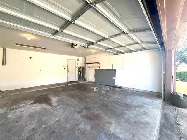 garage with water heater and a garage door opener