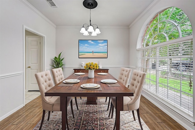 dining area with a chandelier and ornamental molding