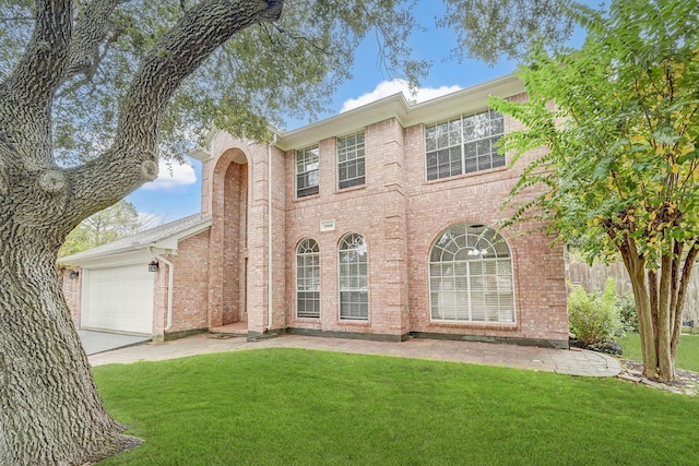 view of front of home with a front lawn and a garage