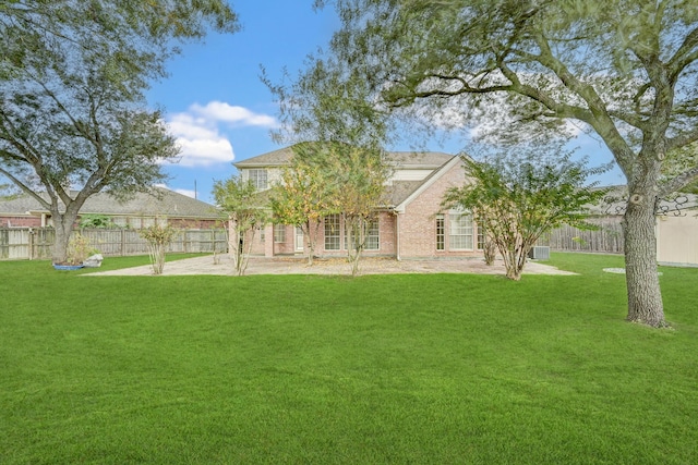 back of house featuring a lawn