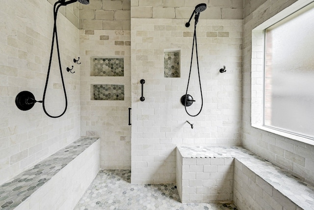 bathroom featuring a tile shower