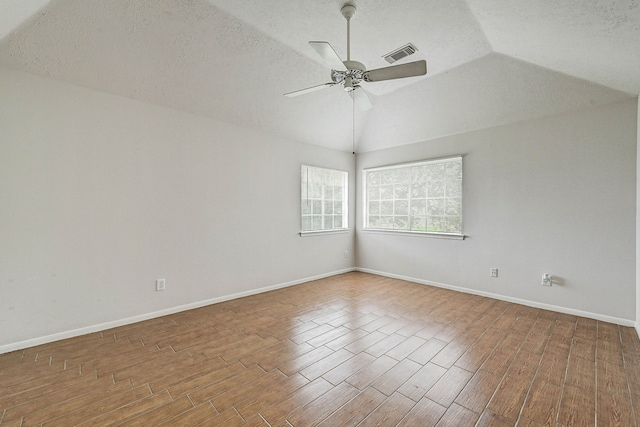 unfurnished room with a textured ceiling, ceiling fan, and lofted ceiling