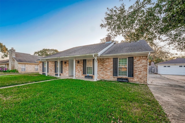 ranch-style home featuring a porch, a garage, and a front lawn