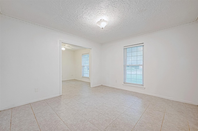 tiled spare room featuring a textured ceiling, ceiling fan, and ornamental molding