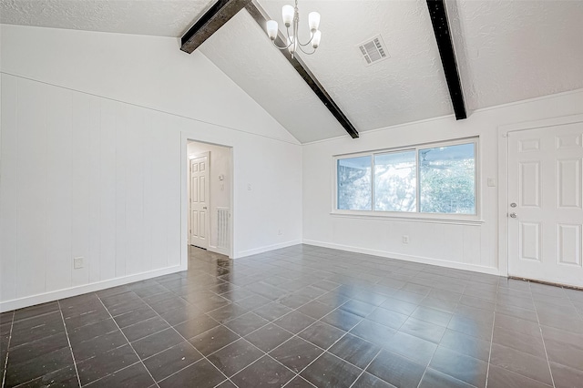 spare room featuring vaulted ceiling with beams, a textured ceiling, and an inviting chandelier