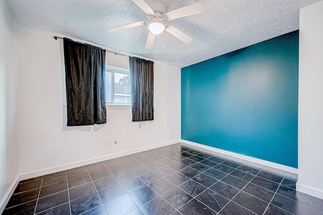 spare room with ceiling fan and a textured ceiling