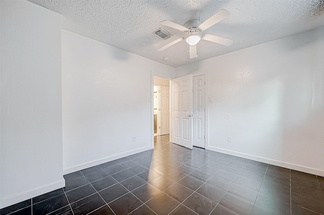 spare room featuring a textured ceiling and ceiling fan