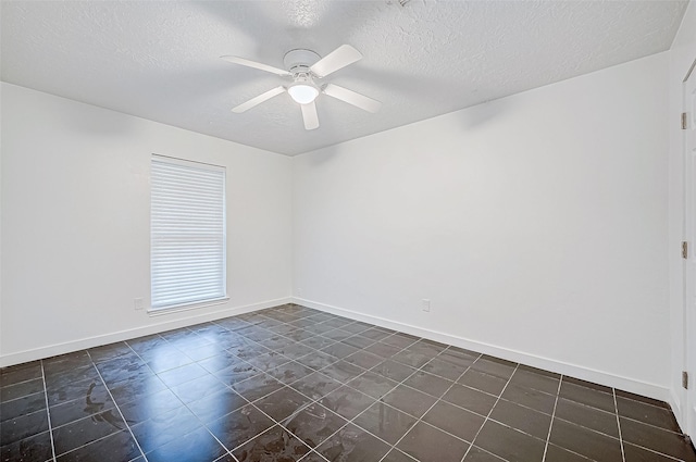 spare room featuring ceiling fan and a textured ceiling