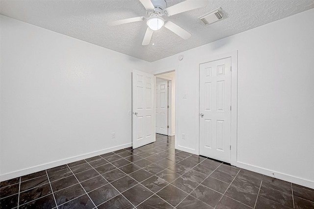 unfurnished bedroom featuring a textured ceiling, a closet, and ceiling fan