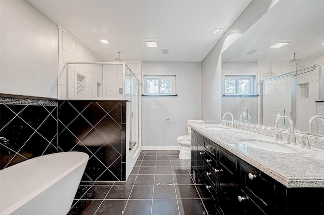 full bathroom with tile patterned floors, vanity, tile walls, shower with separate bathtub, and toilet