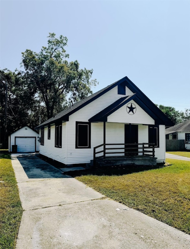 view of front of house featuring an outbuilding, a front lawn, and a garage