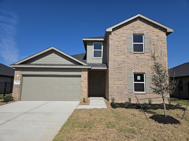 traditional-style house with a garage, driveway, brick siding, and fence