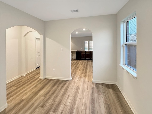 unfurnished room with light hardwood / wood-style flooring