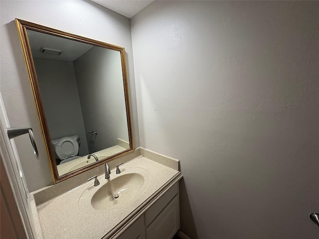 bathroom featuring vanity and toilet