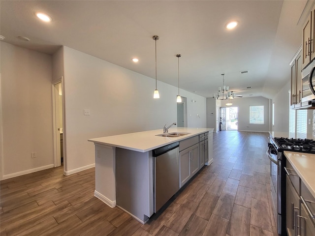 kitchen with pendant lighting, sink, ceiling fan, an island with sink, and appliances with stainless steel finishes