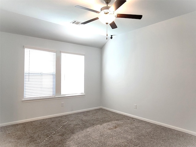 carpeted empty room featuring ceiling fan and vaulted ceiling