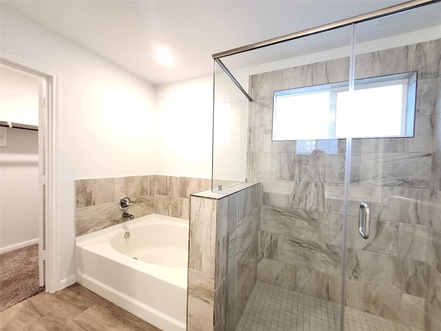 bathroom featuring hardwood / wood-style flooring and separate shower and tub