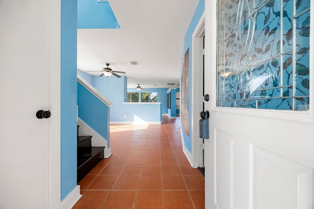 hall with dark tile patterned flooring