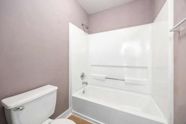 bathroom featuring tile patterned floors, toilet, and tub / shower combination