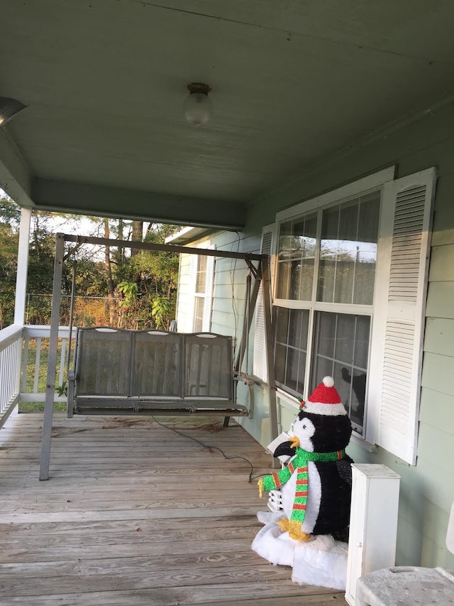 wooden terrace featuring covered porch