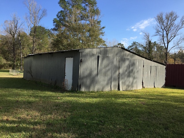 view of outbuilding with a yard