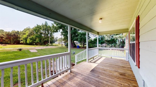 deck with a yard and a porch